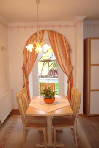 a dining room with a table with a plant on it at Gästehaus Moser in Ramingstein