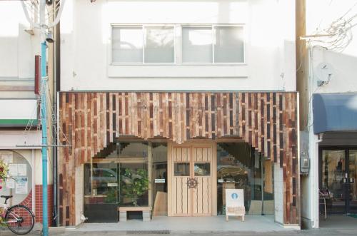 frente a una tienda con fachada de madera en Guest House Minato, en Miyako