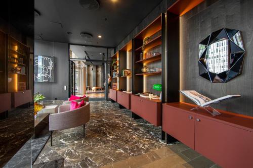 a lobby with a long line of tables and chairs at Clarion Hotel Oslo in Oslo