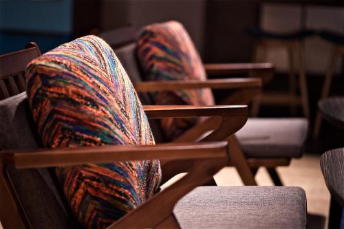 a pair of chairs with a blanket on them at Just Sleep - Ximending in Taipei
