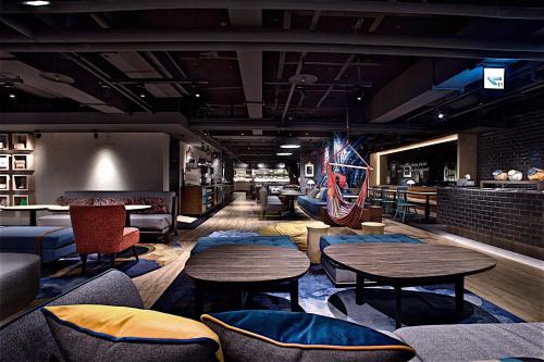 a restaurant with tables and chairs and an american flag at Just Sleep - Ximending in Taipei