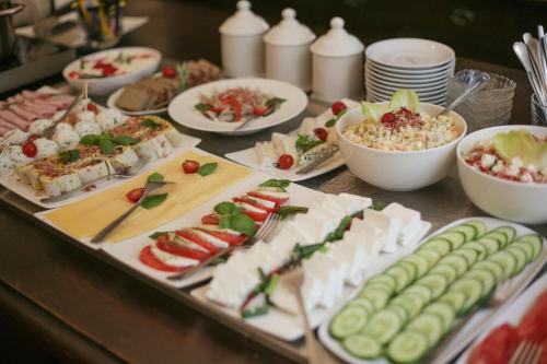 a table with many different types of food on it at Hotel Dwór Polski in Wrocław