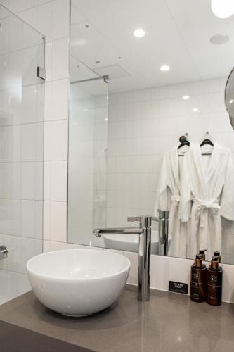 a bathroom with a white sink and a mirror at Clarion Hotel Oslo in Oslo