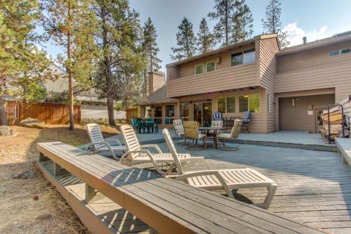 a deck with chairs and tables and a house at 10 Yellow Rail in Sunriver