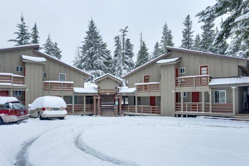 a lodge in the snow with cars parked in the driveway at Edelweiss Retreat in Government Camp