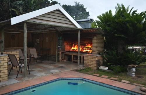 a backyard with a fireplace next to a swimming pool at IRONWOOD LODGE in Pennington
