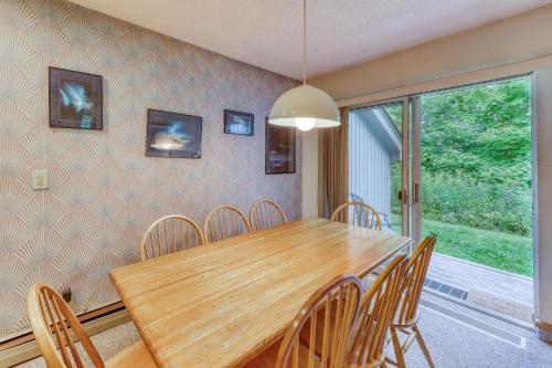 a dining room with a wooden table and chairs at The Woods: Townhouse-F3 in Killington