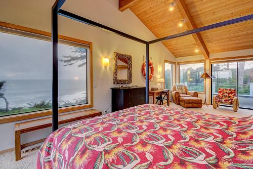 a bedroom with a large bed and large windows at Brammer's Bluff in Sea Ranch