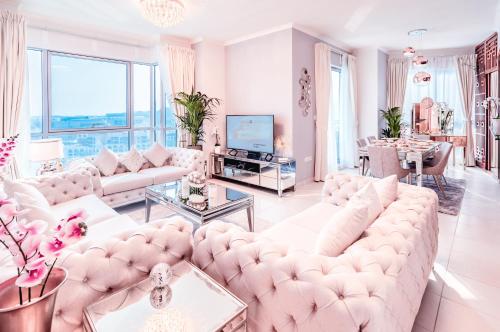 ein Wohnzimmer mit weißen Möbeln und großen Fenstern in der Unterkunft Elite Royal Apartment - Full Burj Khalifa and Fountain View - Caesar in Dubai