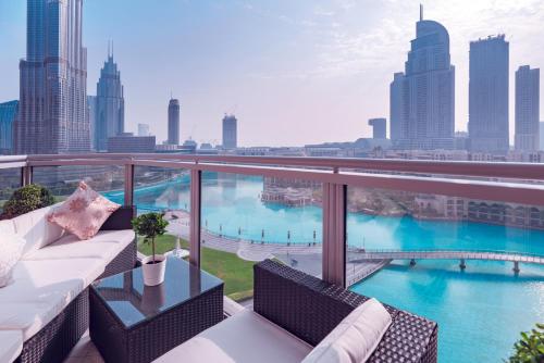 a balcony with a couch and a view of the city at Elite Royal Apartment - Full Burj Khalifa and Fountain View - Caesar in Dubai