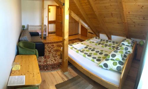 a bedroom with a bed and a table in a room at Antal-tavi Fogadó és Horgászparadicsom in Szentes