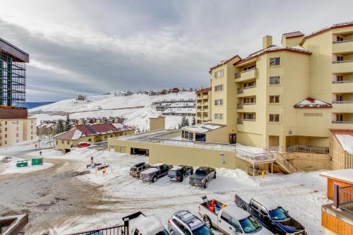 a parking lot with cars parked outside of a building at Slopeside Paradise at Axtel in Mount Crested Butte