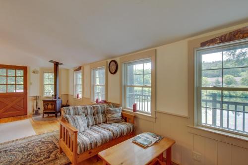 a living room with a couch and a table and windows at Ludlow's Gem in Ludlow