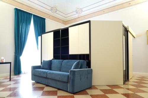 a blue couch in a living room with blue curtains at Rosita Luxury Apartments in Apricena
