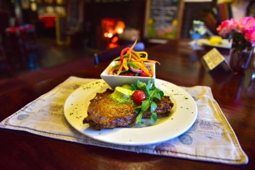 a plate of food with a salad on a table at Rawdons Hotel & Brewery in Nottingham Road