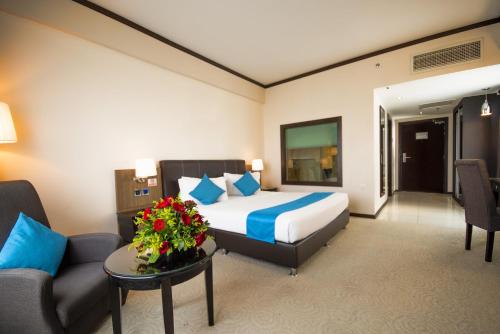 a hotel room with a bed and a couch at Kinta Riverfront Hotel & Suites in Ipoh