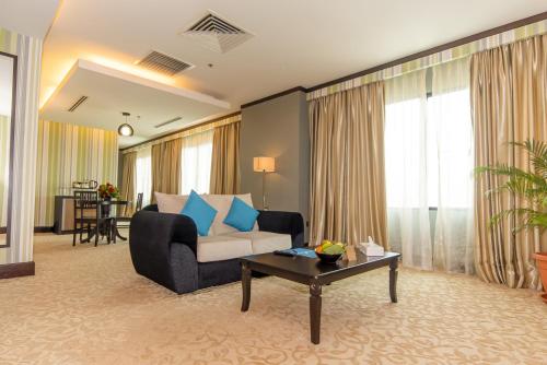 a living room with a couch and a table at Kinta Riverfront Hotel & Suites in Ipoh