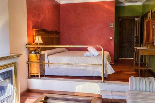 a room with a bed, a chair, and a window at Hotel Alabardero in Seville