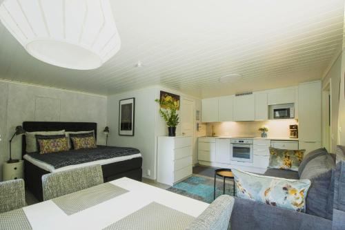 a living room with a bed and a kitchen at Airport Mint House Studio in Vantaa