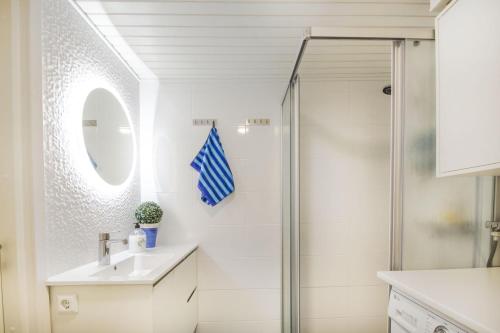 a bathroom with a shower and a sink at Airport Mint House Studio in Vantaa