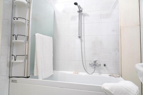 a bathroom with a shower and a tub and a sink at Rosita Luxury Apartments in Apricena