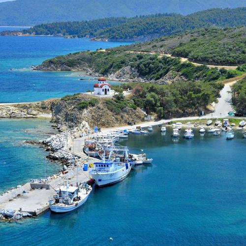 a group of boats are docked in a harbor at Almira - rooms to let in Nea Roda