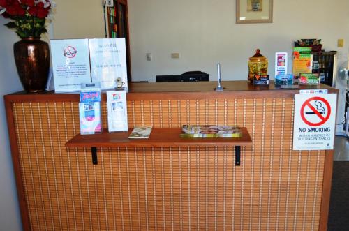 an orange tiled counter with a no smoking sign on it at Redland Bay Motel in Redland Bay