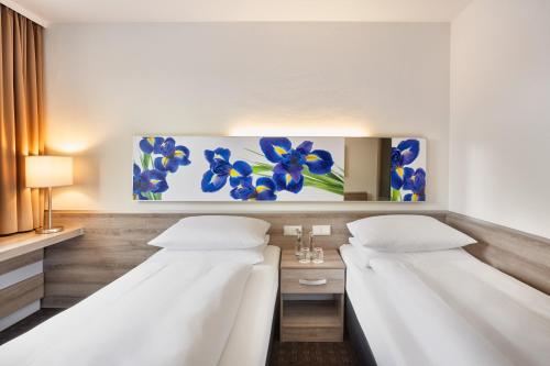 Letto o letti in una camera di H+ Hotel Frankfurt Airport West