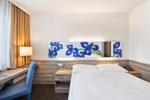 Letto o letti in una camera di H+ Hotel Frankfurt Airport West