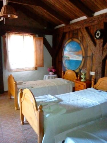 a bedroom with two beds and a mirror at Finca El Abuelo in Barbate