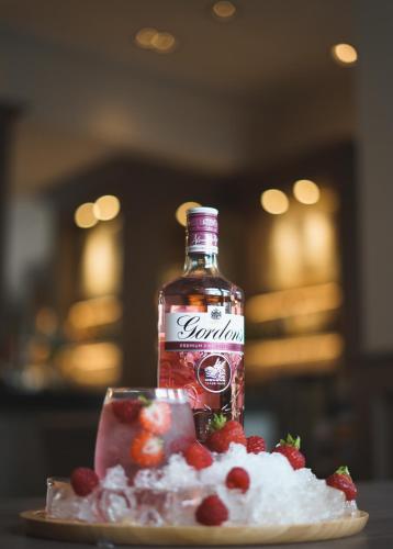 a bottle of syrup sitting on a plate with fruit at Inverness Palace Hotel & Spa, WorldHotels Distinctive in Inverness