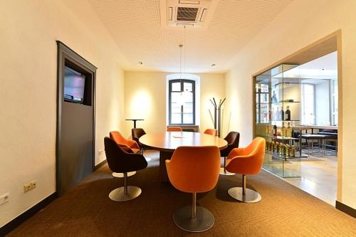 a dining room with a table and chairs at Domaine Leidinger in Saarbrücken