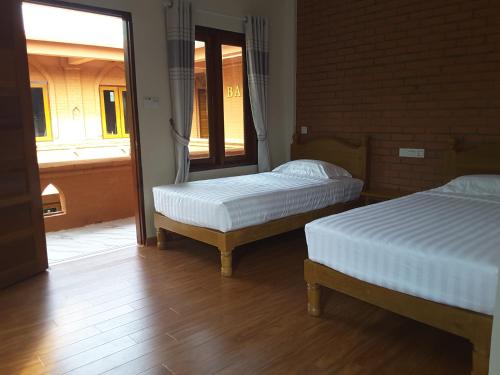 Voodi või voodid majutusasutuse A Little Bit of BAGAN HOTEL toas