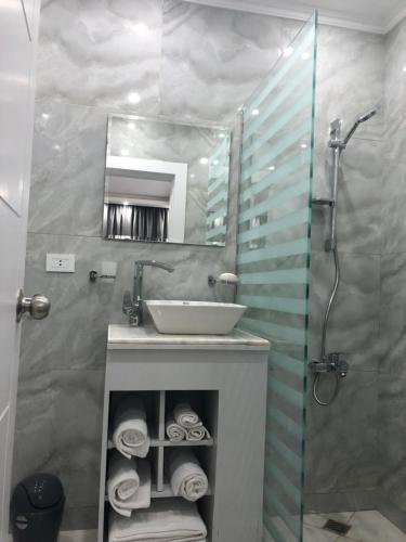 a bathroom with a sink and a shower with a mirror at Elite Pyramids Inn Islamic inn in Cairo