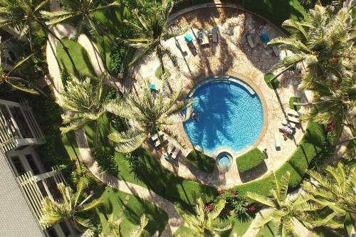 an overhead view of a swimming pool with palm trees at Stunning Luxurious Ocean Villa with Ocean Views From All bedrooms. in Kahuku