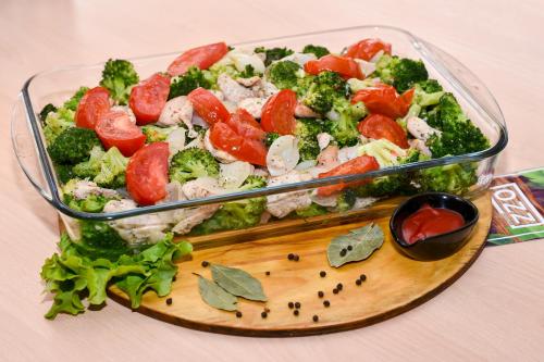 a salad in a glass container on a cutting board at Inn OZZ in Karagandy