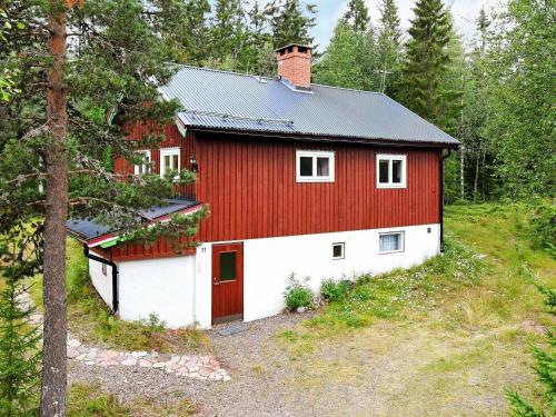 a red and white barn in the woods at 8 person holiday home in S LEN in Lindvallen