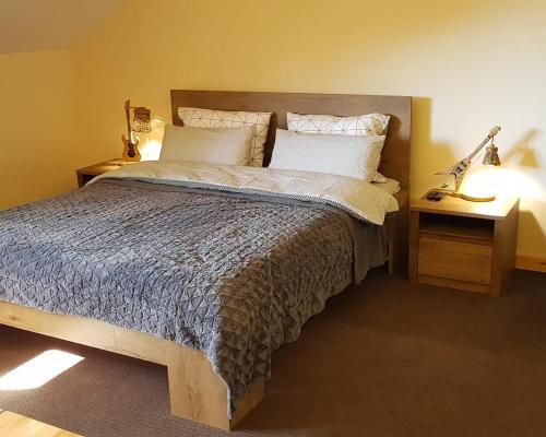 a bedroom with a large bed with two night stands at New Gudauri Suites in Gudauri