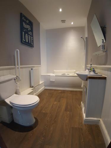 a bathroom with a toilet and a sink at Bull Inn in Reading