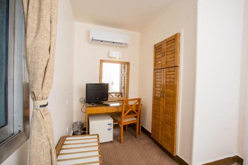 a room with a desk with a computer and a window at Hapi Hotel in Aswan