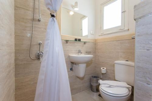a bathroom with a toilet and a sink at Hapi Hotel in Aswan
