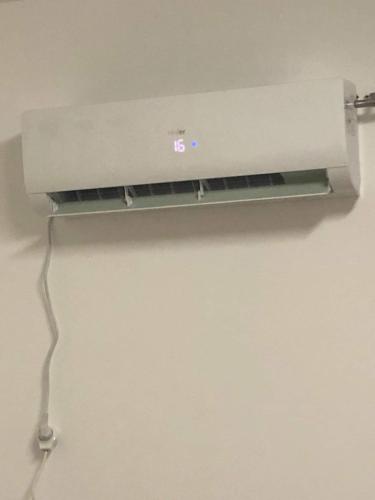 a light hanging on a wall in a room at Joseph apartment in Bethlehem