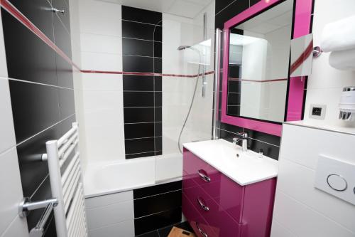 a bathroom with a purple sink and a mirror at Hotel des Celestins in Lyon