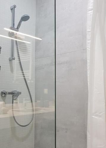 a shower with a glass door in a bathroom at New Gudauri Suites in Gudauri