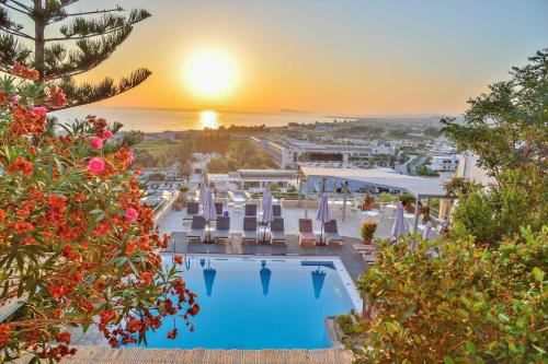 a view of the pool at a resort with the sunset at Aphea Village in Kolymvari