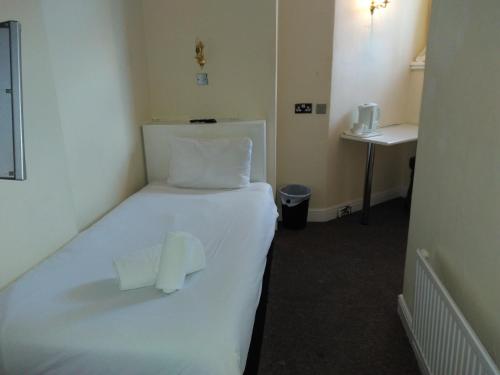 A bed or beds in a room at The Crown Hotel 