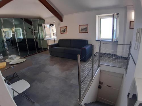a living room with a couch and a table at La Torre by Holiday World in Bogliasco