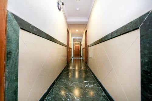 a hallway with a walkway in a building at Hotel Lucky Goregaon in Mumbai