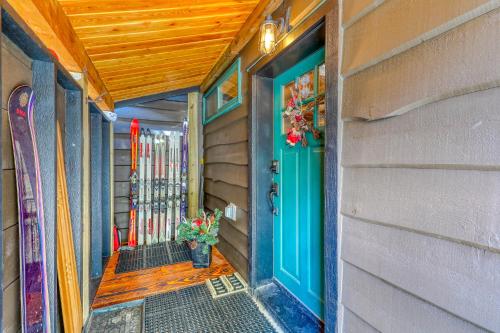 a home with a blue door and skis on a wall at Wy'east Nest in Government Camp