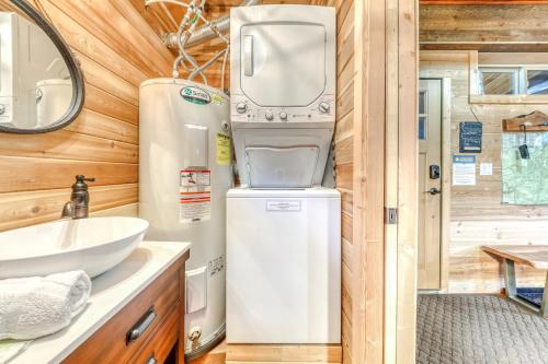 a bathroom with a washer and dryer and a sink at Wy'east Nest in Government Camp